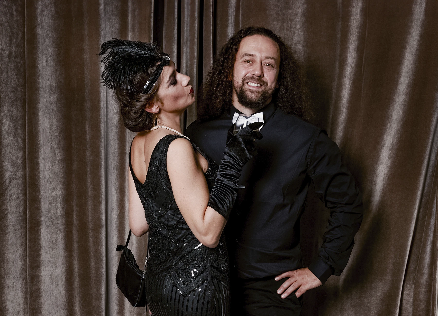 Portrait d’un couple dans un moment de tendresse, posant devant une draperie, réalisé lors d’une soirée d’anniversaire sur le thème des années 20 à l’hôtel Vernet par Laurène Zabary.