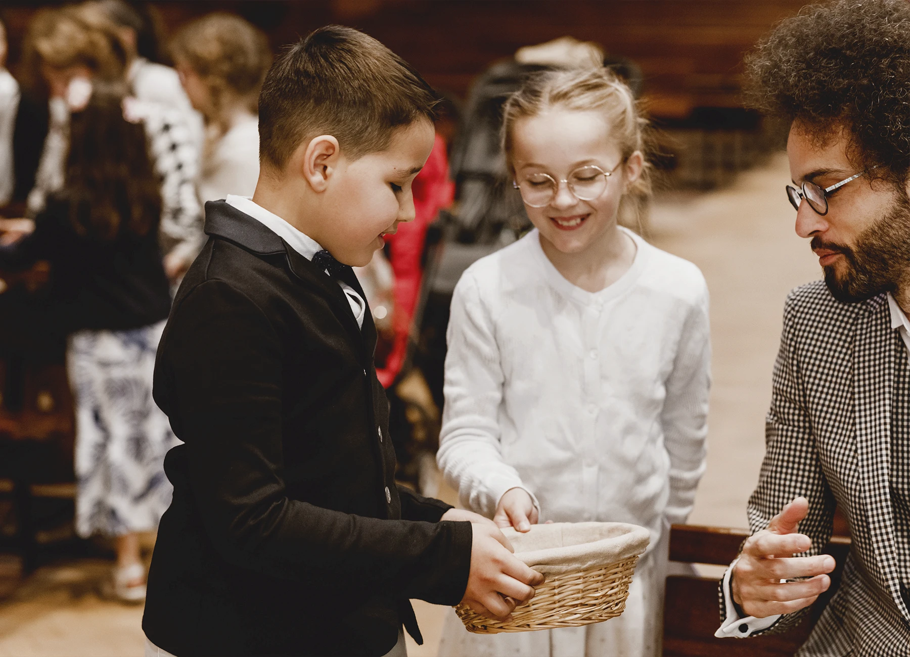 Les enfants de la famille font la quête dans l’église Saint-Joseph de Montrouge pendant un baptême, immortalisés par Laurène Zabary.